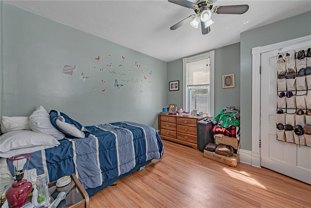 121 Hamilton Avenue Vandergrift, PA 15690 - Photo 16 of 25 a bed room with furniture and wooden floor