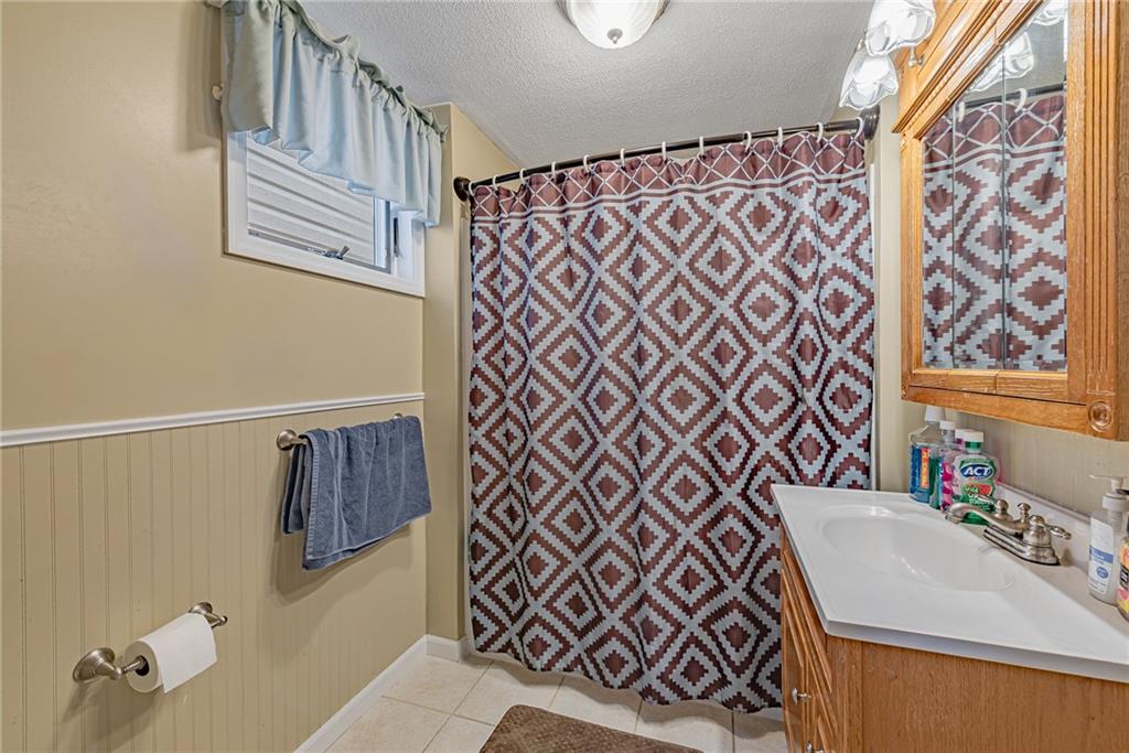 121 Hamilton Avenue Vandergrift, PA 15690 - Photo 17 of 25 a bathroom with a sink a vanity and a shower