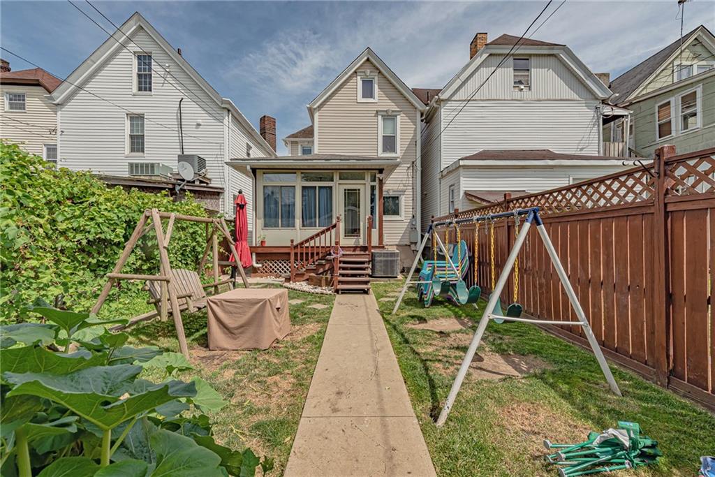 121 Hamilton Avenue Vandergrift, PA 15690 - Photo 24 of 25 a view of a white house with a big yard and potted plants