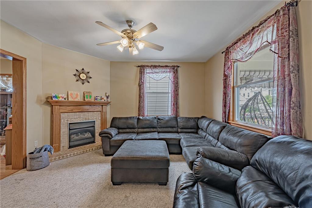 121 Hamilton Avenue Vandergrift, PA 15690 - Photo 3 of 25 a living room with furniture a fireplace and a large mirror