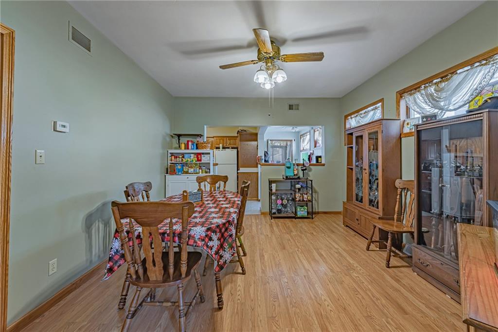 121 Hamilton Avenue Vandergrift, PA 15690 - Photo 6 of 25 a view of a dining room with furniture and wooden floor