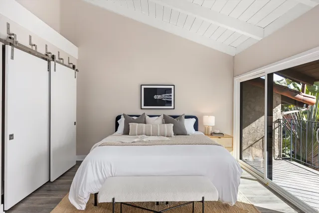 a bedroom with a large bed and a window