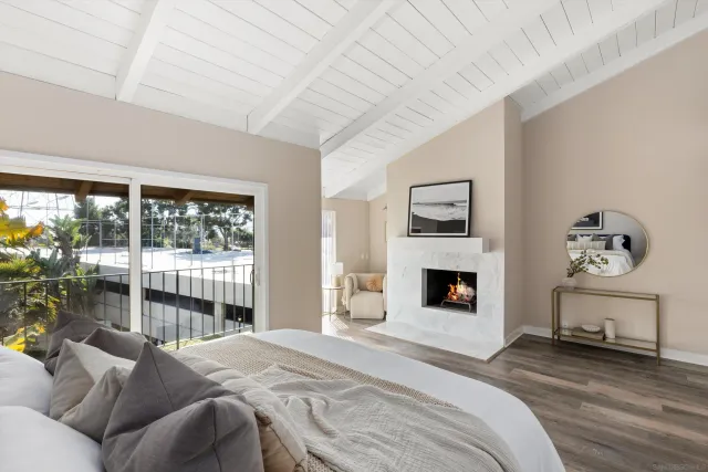 a bedroom with a bed and a fireplace