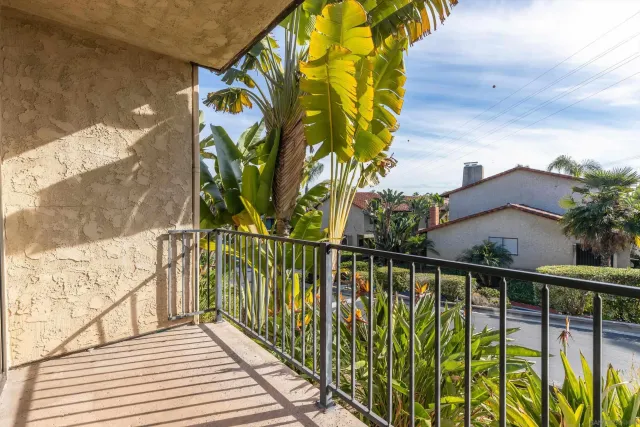 a view of balcony with wooden floor and fence