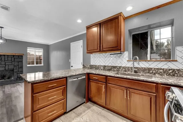 a kitchen with granite countertop cabinets sink and window