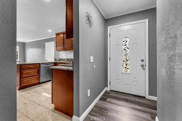 an empty room with windows and cabinet