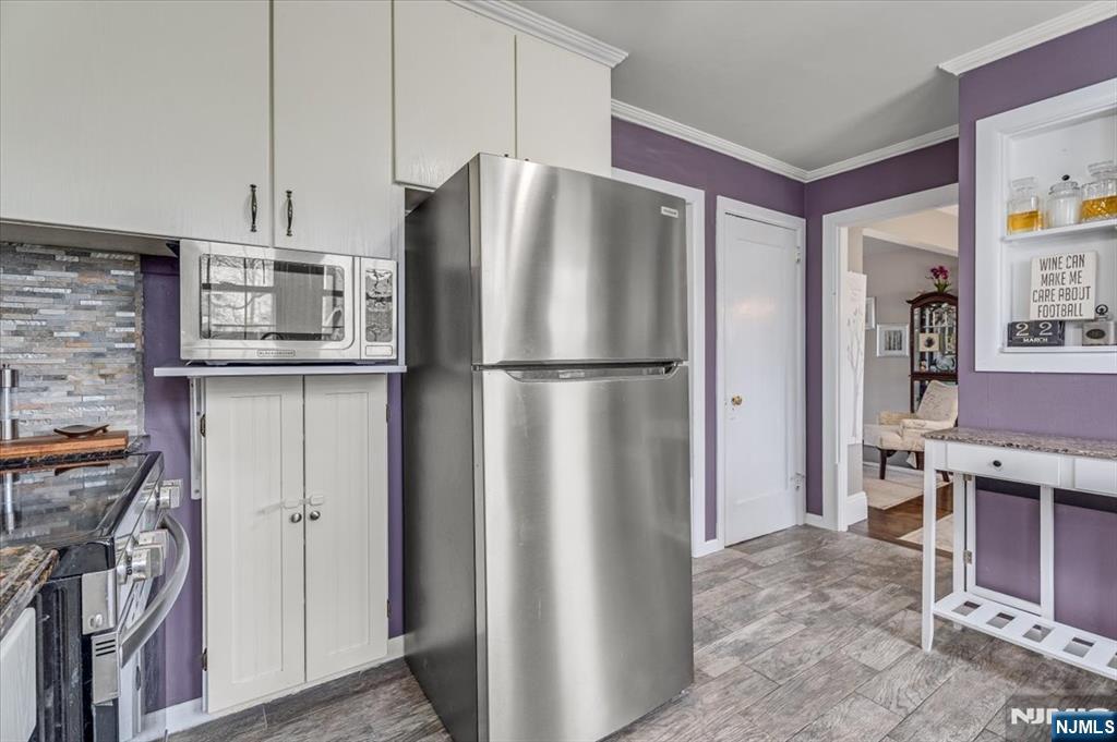 27 Prospect Avenue Pompton Plains, NJ 07444 - Photo 11 of 26 a metallic refrigerator freezer sitting in a kitchen