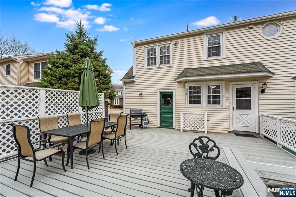 27 Prospect Avenue Pompton Plains, NJ 07444 - Photo 22 of 26 a view of a patio with table and chairs with wooden floor and fence