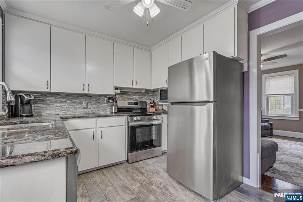 27 Prospect Avenue Pompton Plains, NJ 07444 - Photo 9 of 26 a kitchen with stainless steel appliances granite countertop a refrigerator a stove a sink and a granite counter tops
