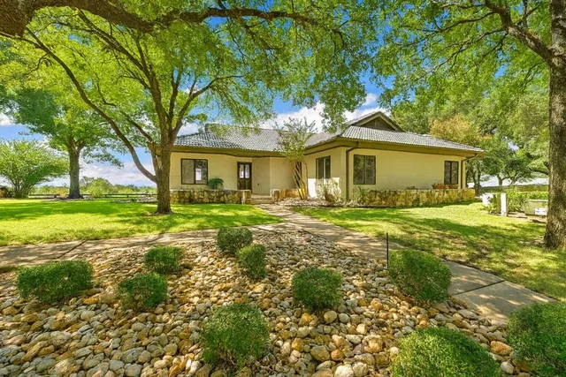 a front view of a house with garden