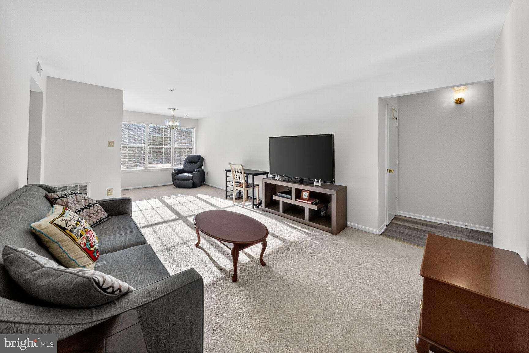 14901 McKisson Court, Unit 7CC Silver Spring, MD 20906 - Photo 2 of 34 a living room with furniture and a flat screen tv