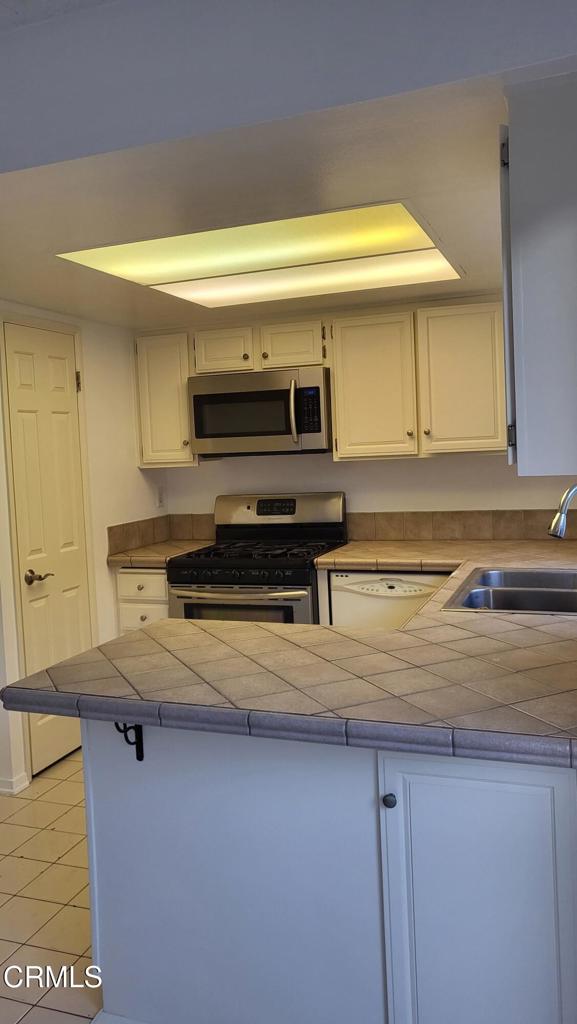 2065 East Bard Road Oxnard, CA 93033 - Photo 3 of 18 a kitchen with a stove and a microwave