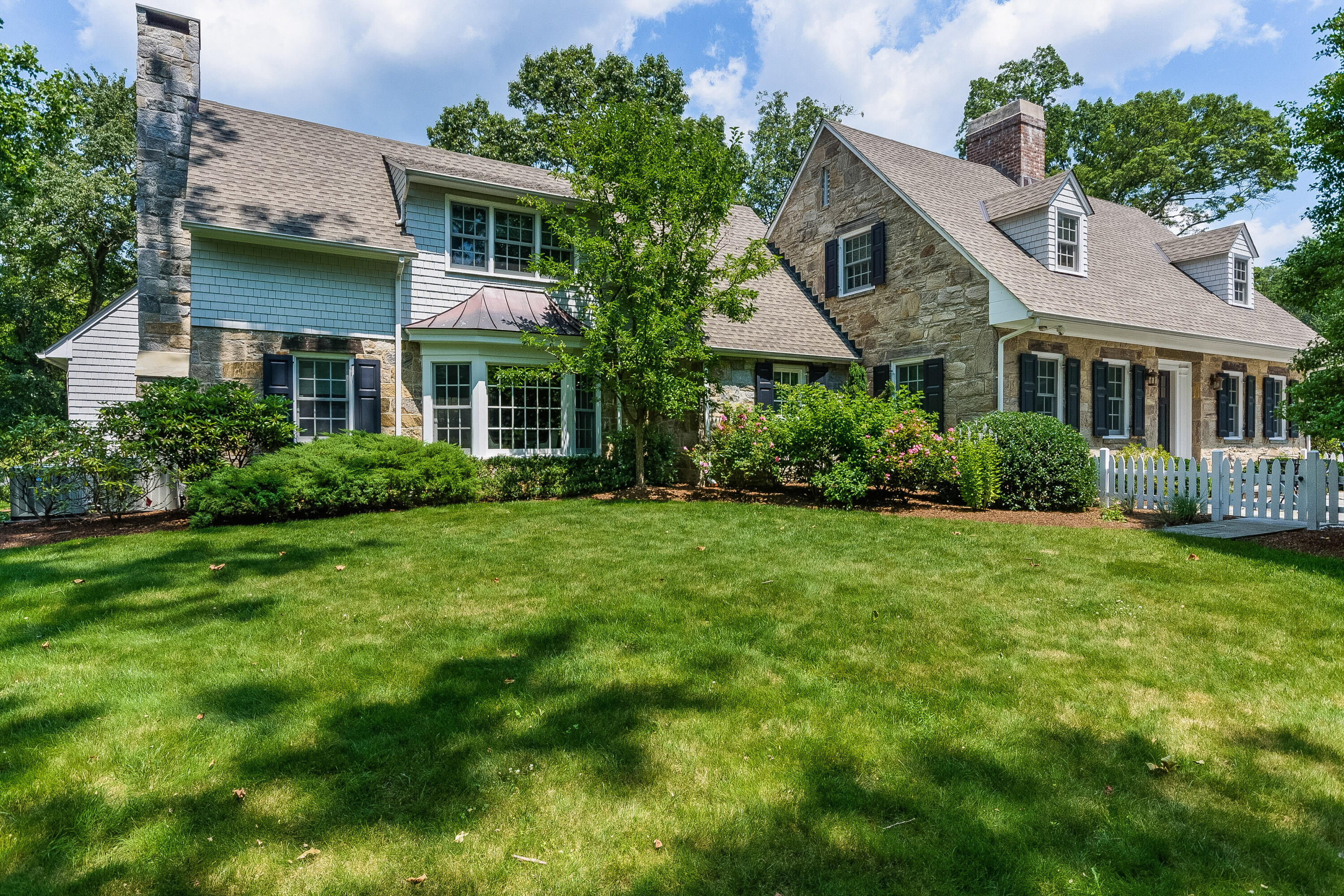 a front view of house with yard and green space