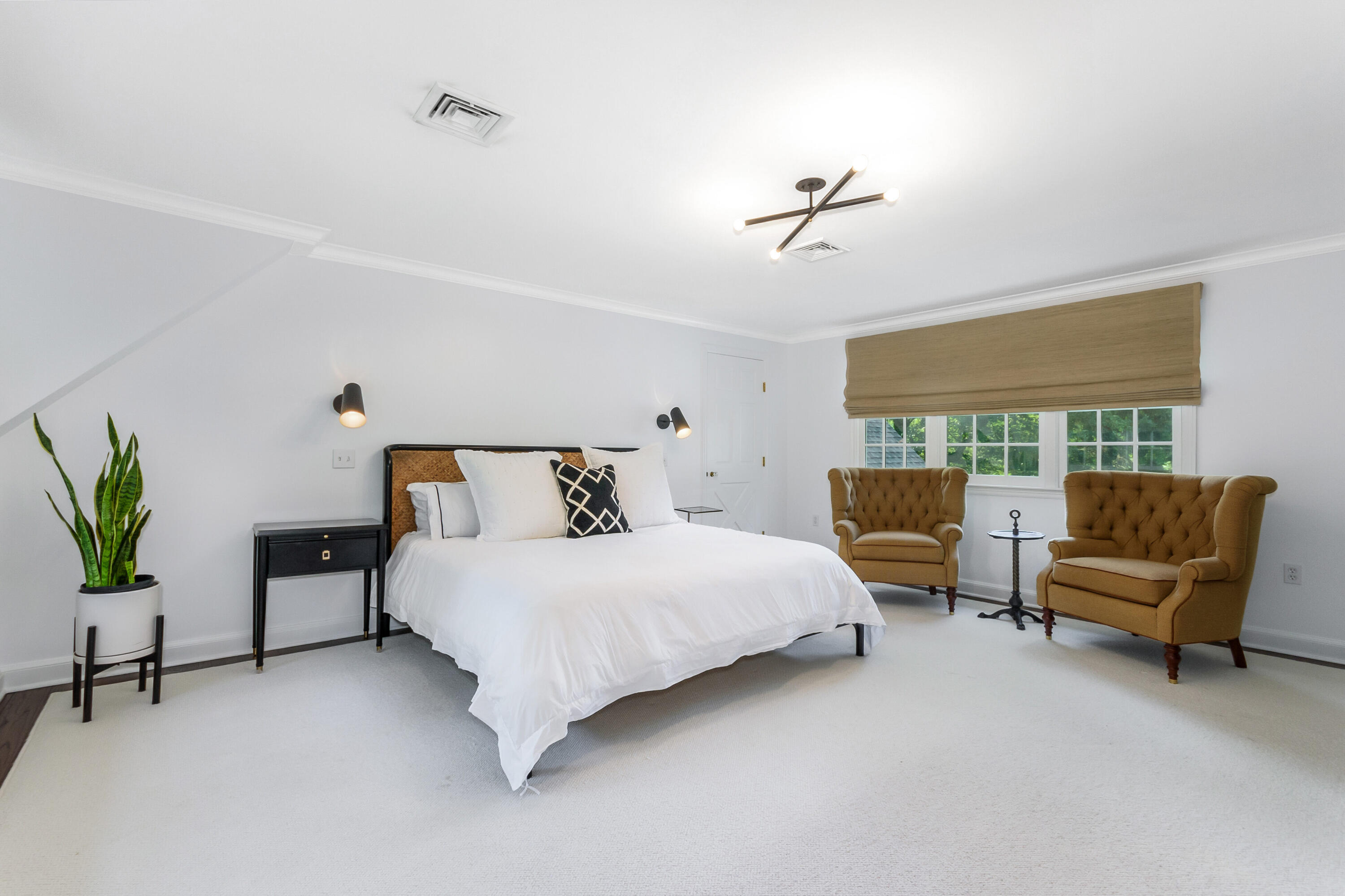 9 Sylvan Road Darien, CT 06820 - Photo 22 of 39 a spacious bedroom with a bed and a couch