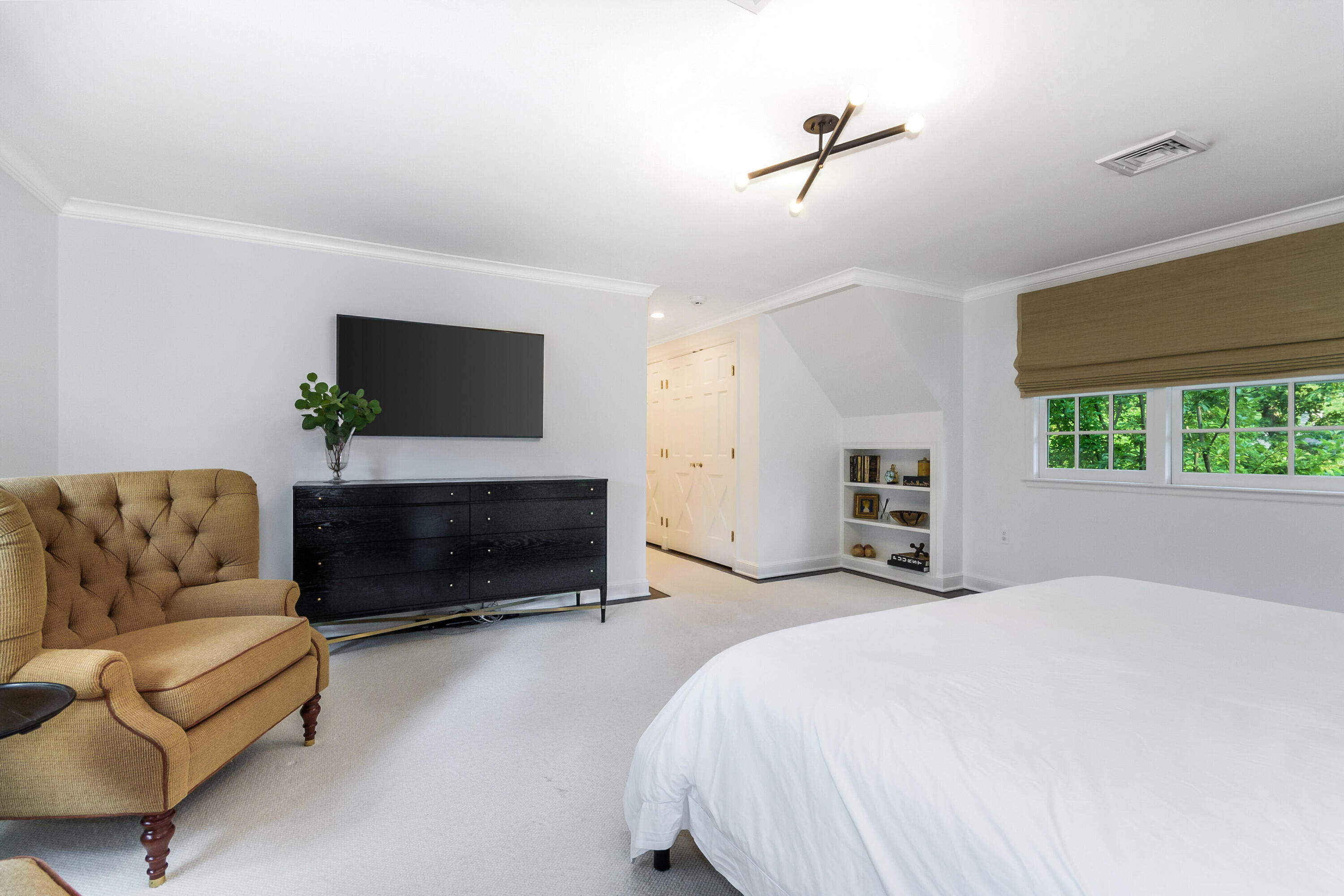 9 Sylvan Road Darien, CT 06820 - Photo 23 of 39 a bedroom with furniture and a flat screen tv