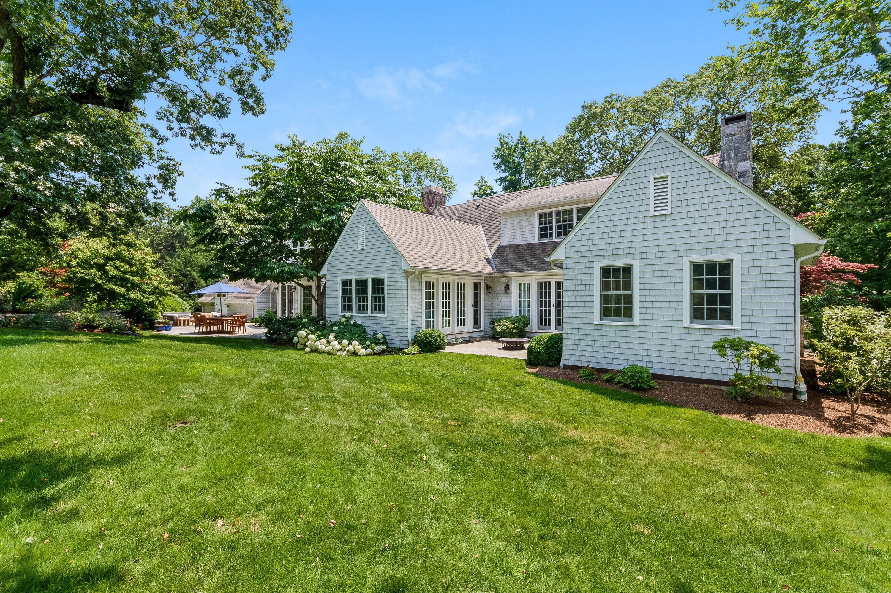 9 Sylvan Road Darien, CT 06820 - Photo 31 of 39 a front view of a house with a yard and trees