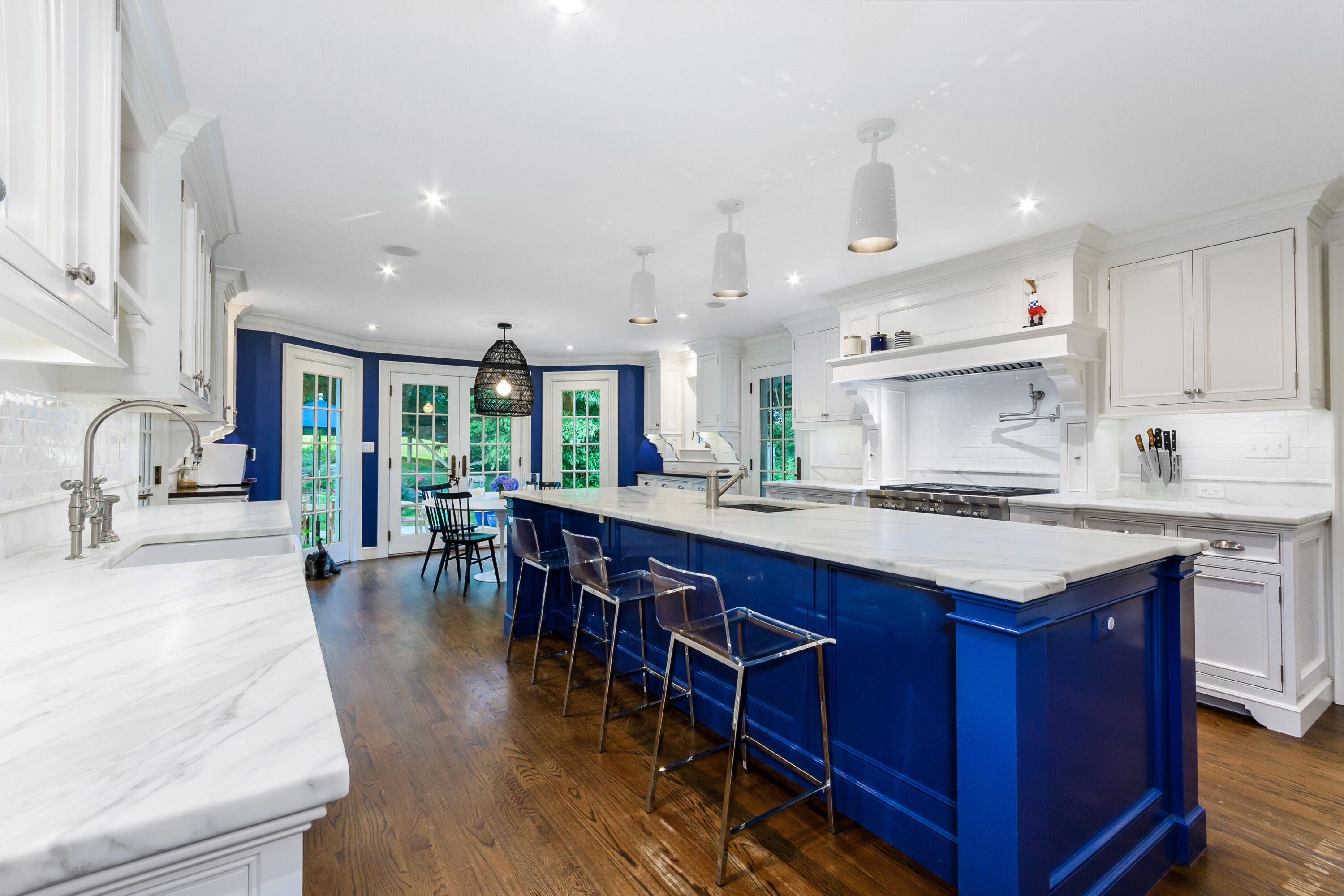 9 Sylvan Road Darien, CT 06820 - Photo 10 of 39 a kitchen with stainless steel appliances granite countertop a stove a sink dishwasher and a dining table with wooden floor