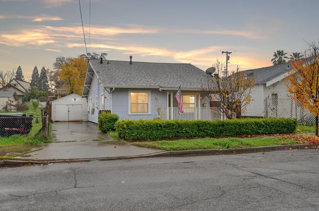 a front view of house with yard and green space