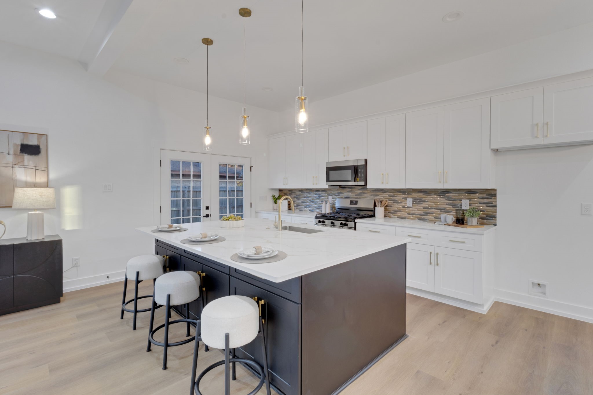 4202 Plaag Street Houston, TX 77016 - Photo 13 of 38 Gourmet kitchen featuring quartz countertops, stylish backsplash, and a large island with pendant lighting—perfect for entertaining.