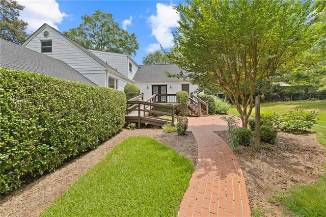 a view of a garden with a house