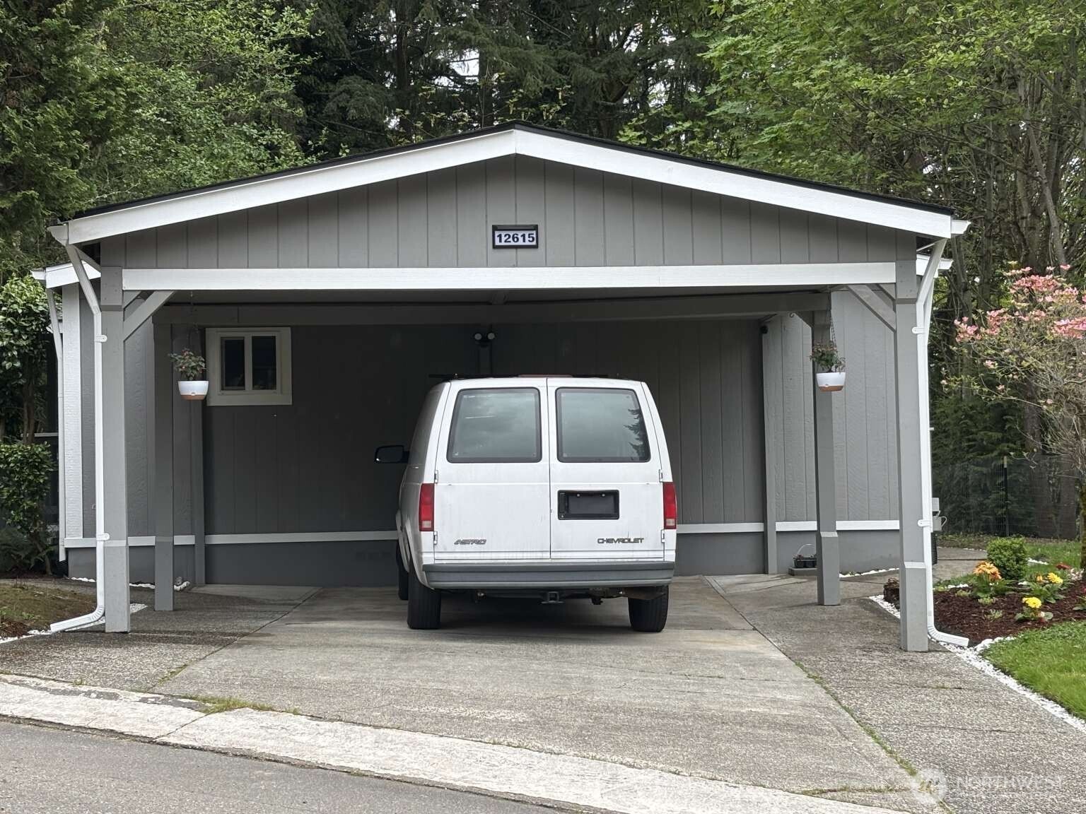 12615 Northeast 189th Street Bothell, WA 98011 - Photo 1 of 40 a car parked in front of white house