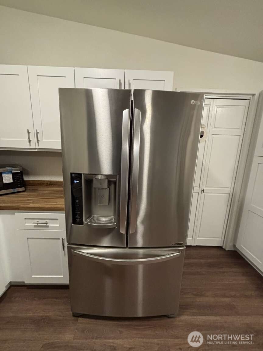 12615 Northeast 189th Street Bothell, WA 98011 - Photo 11 of 40 a metallic refrigerator freezer sitting in a kitchen