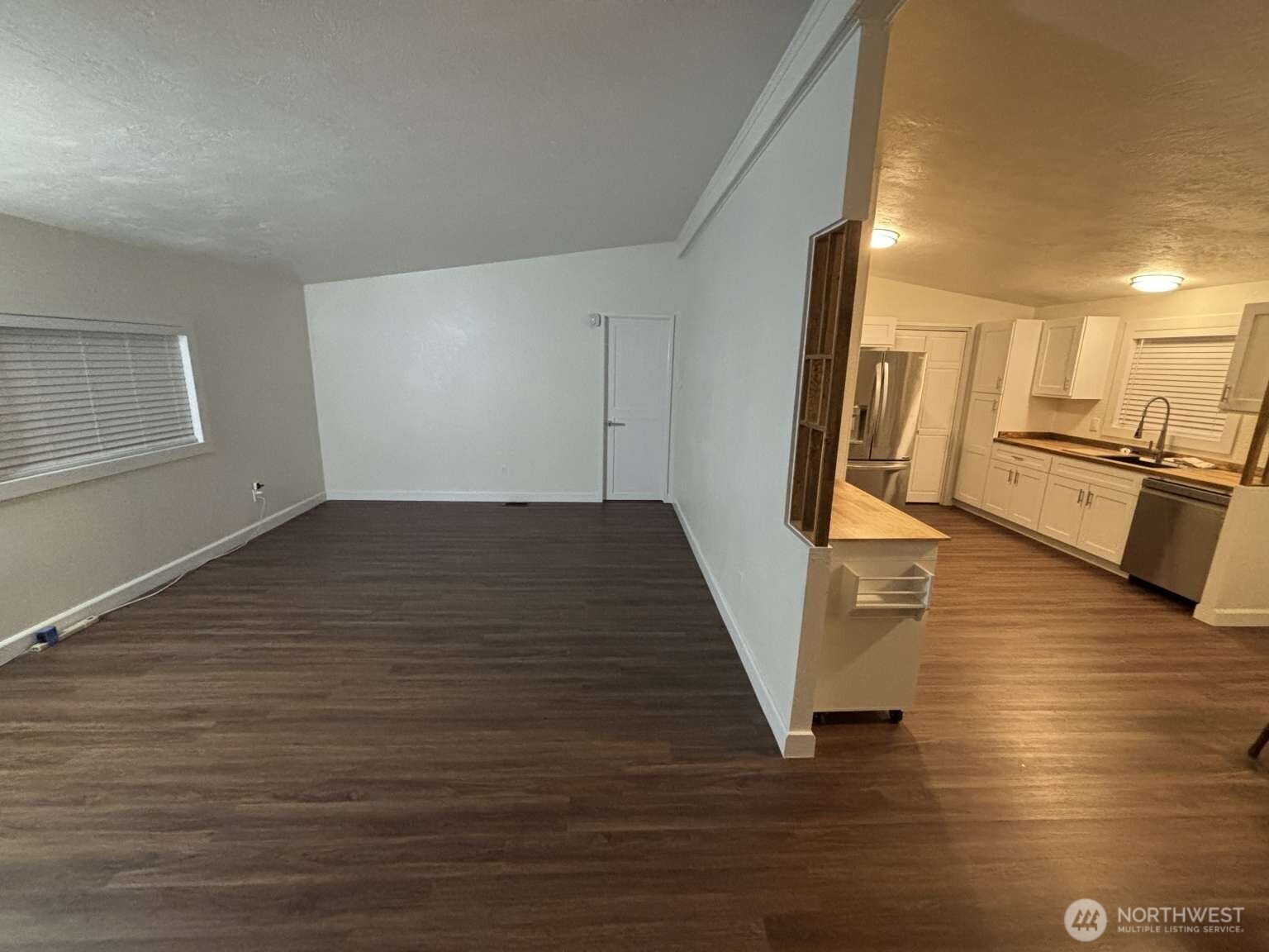 12615 Northeast 189th Street Bothell, WA 98011 - Photo 16 of 40 a view of a kitchen with wooden floor and a sink