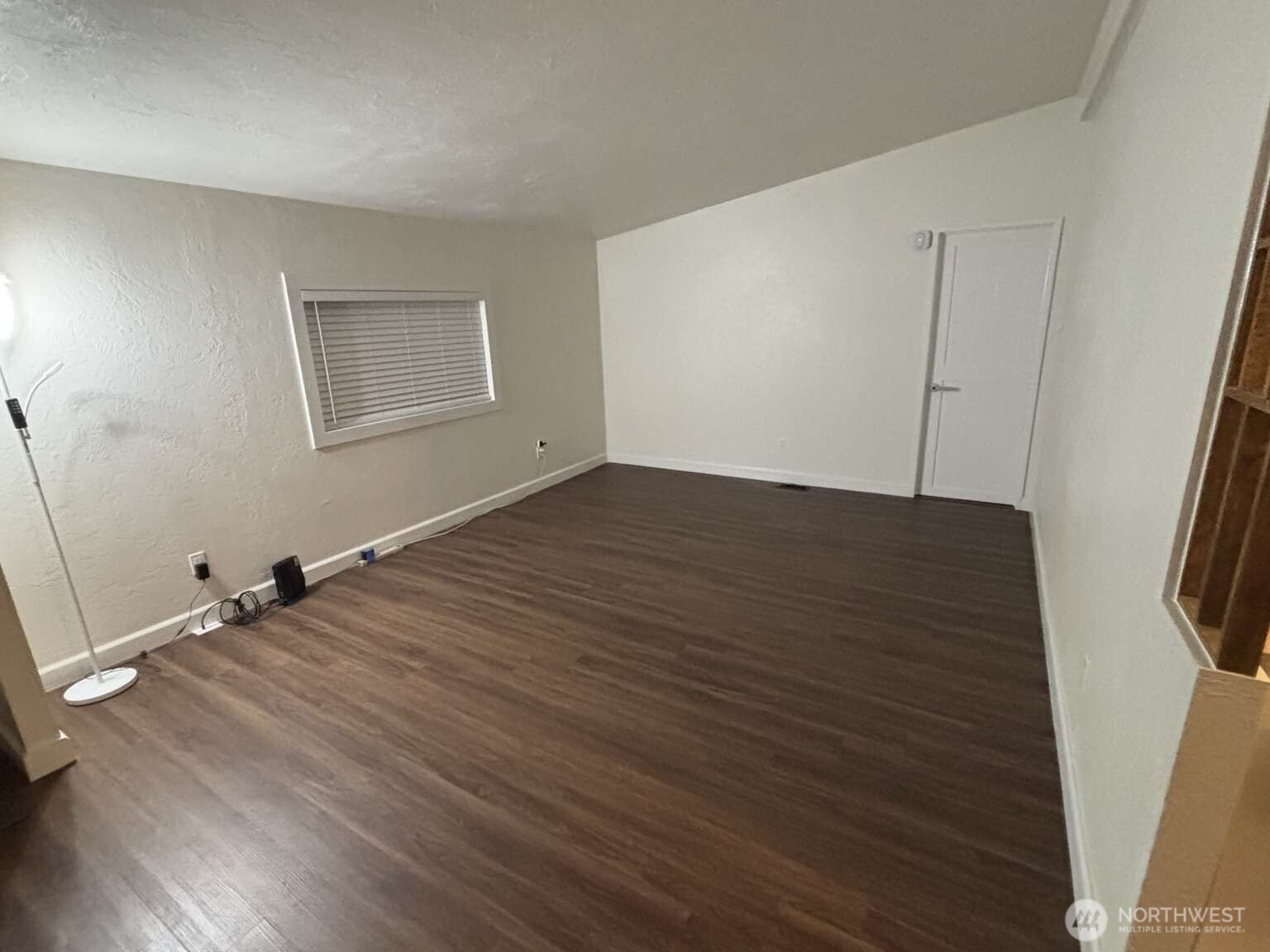 12615 Northeast 189th Street Bothell, WA 98011 - Photo 20 of 40 an empty room with wooden floor and windows