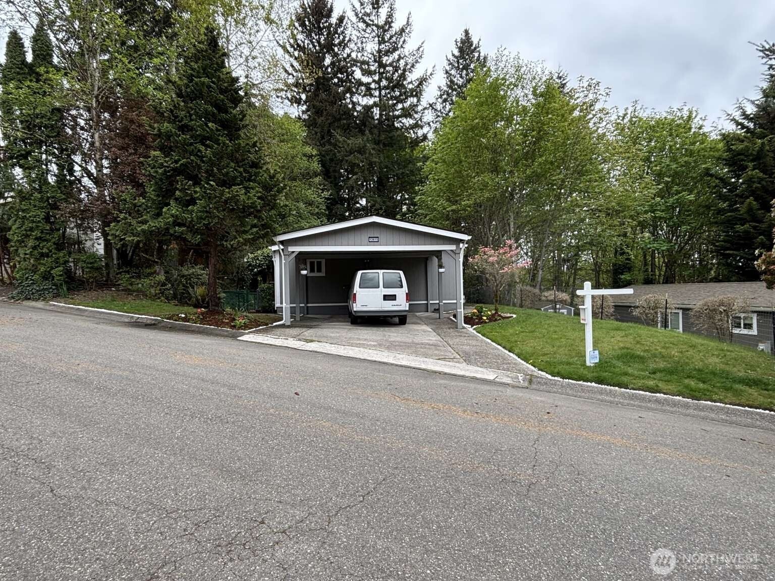 12615 Northeast 189th Street Bothell, WA 98011 - Photo 2 of 40 a view of a car in front of house with trees