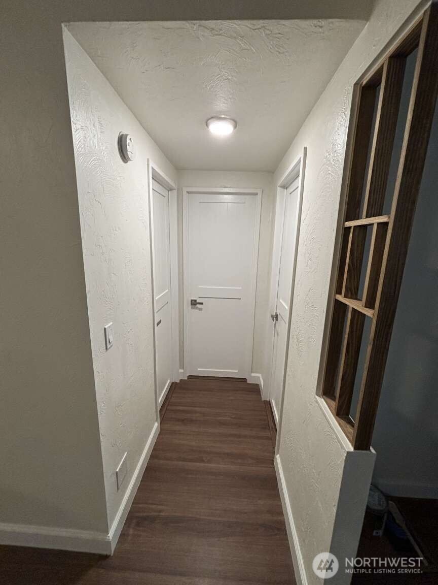 12615 Northeast 189th Street Bothell, WA 98011 - Photo 23 of 40 a view of a hallway with wooden floor and staircase
