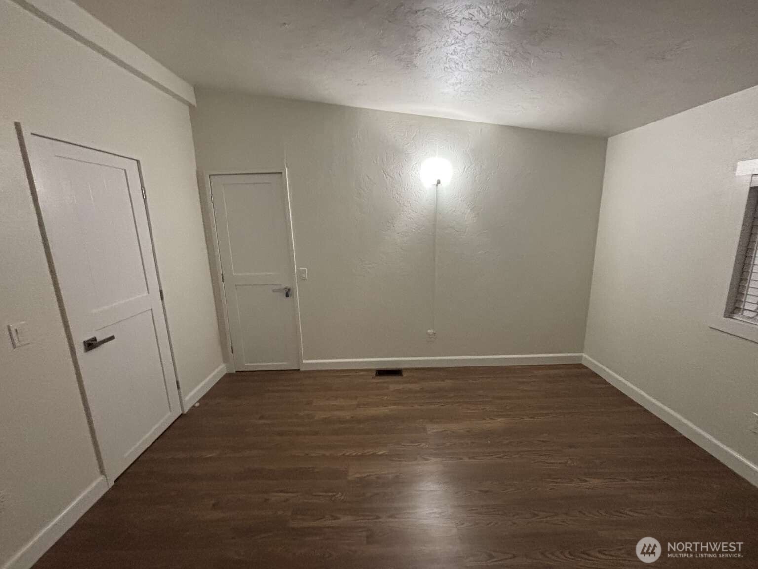 12615 Northeast 189th Street Bothell, WA 98011 - Photo 26 of 40 a view of an empty room with wooden floor
