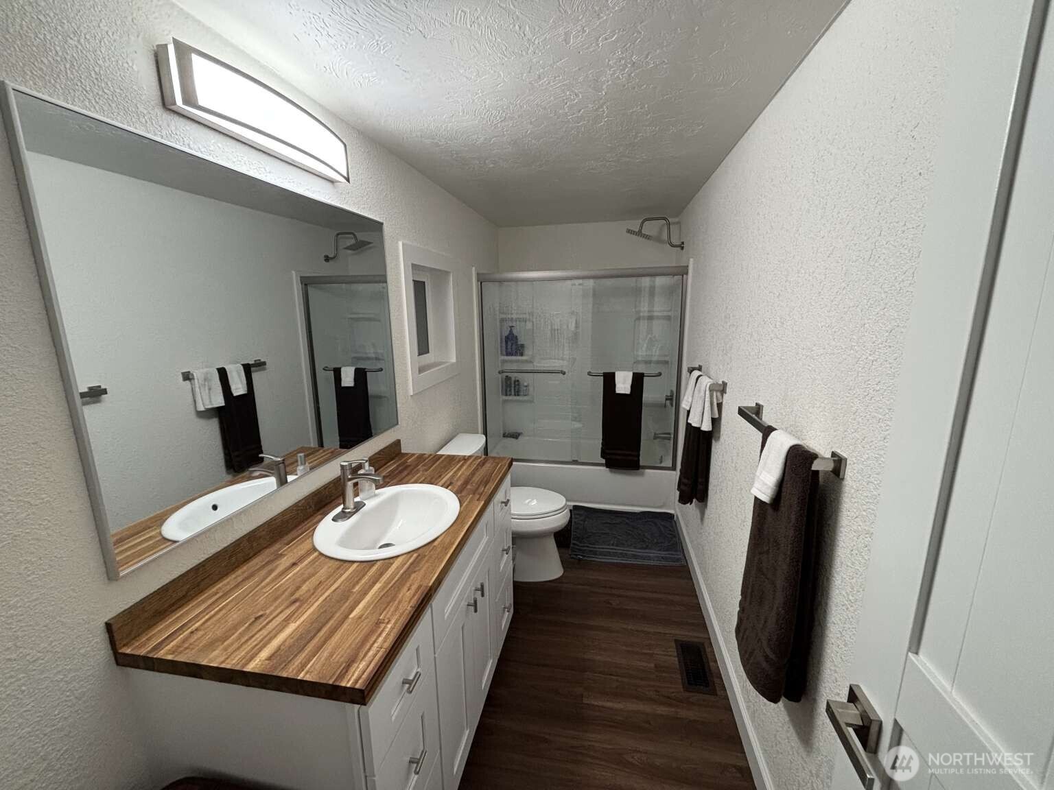 12615 Northeast 189th Street Bothell, WA 98011 - Photo 28 of 40 a bathroom with a sink a toilet and a mirror