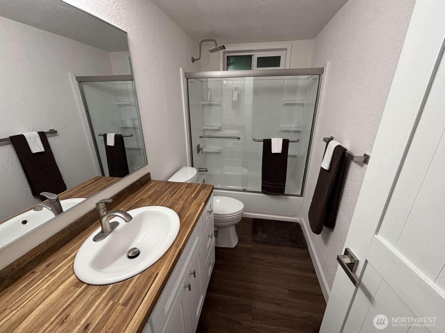 12615 Northeast 189th Street Bothell, WA 98011 - Photo 30 of 40 a bathroom with a sink a toilet a mirror and shower