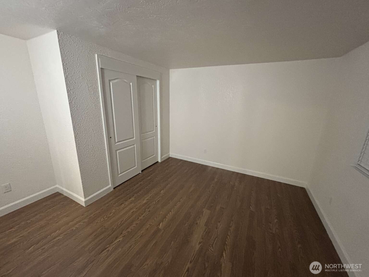 12615 Northeast 189th Street Bothell, WA 98011 - Photo 34 of 40 a view of an empty room with wooden floor
