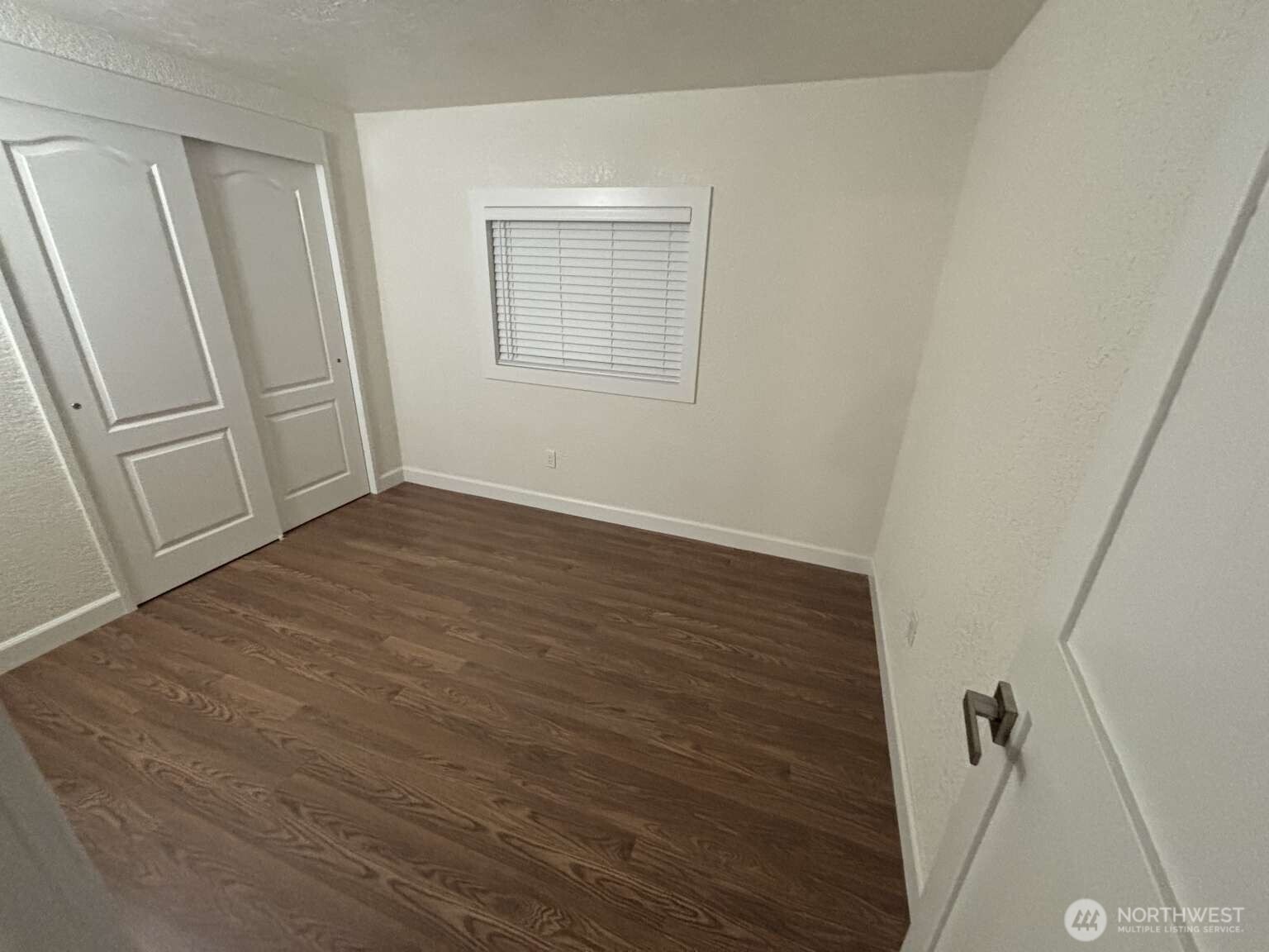 12615 Northeast 189th Street Bothell, WA 98011 - Photo 36 of 40 a view of an empty room with wooden floor and a window