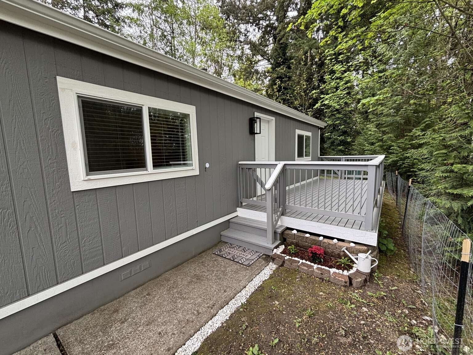 12615 Northeast 189th Street Bothell, WA 98011 - Photo 4 of 40 a backyard of a house with wooden deck and outdoor seating