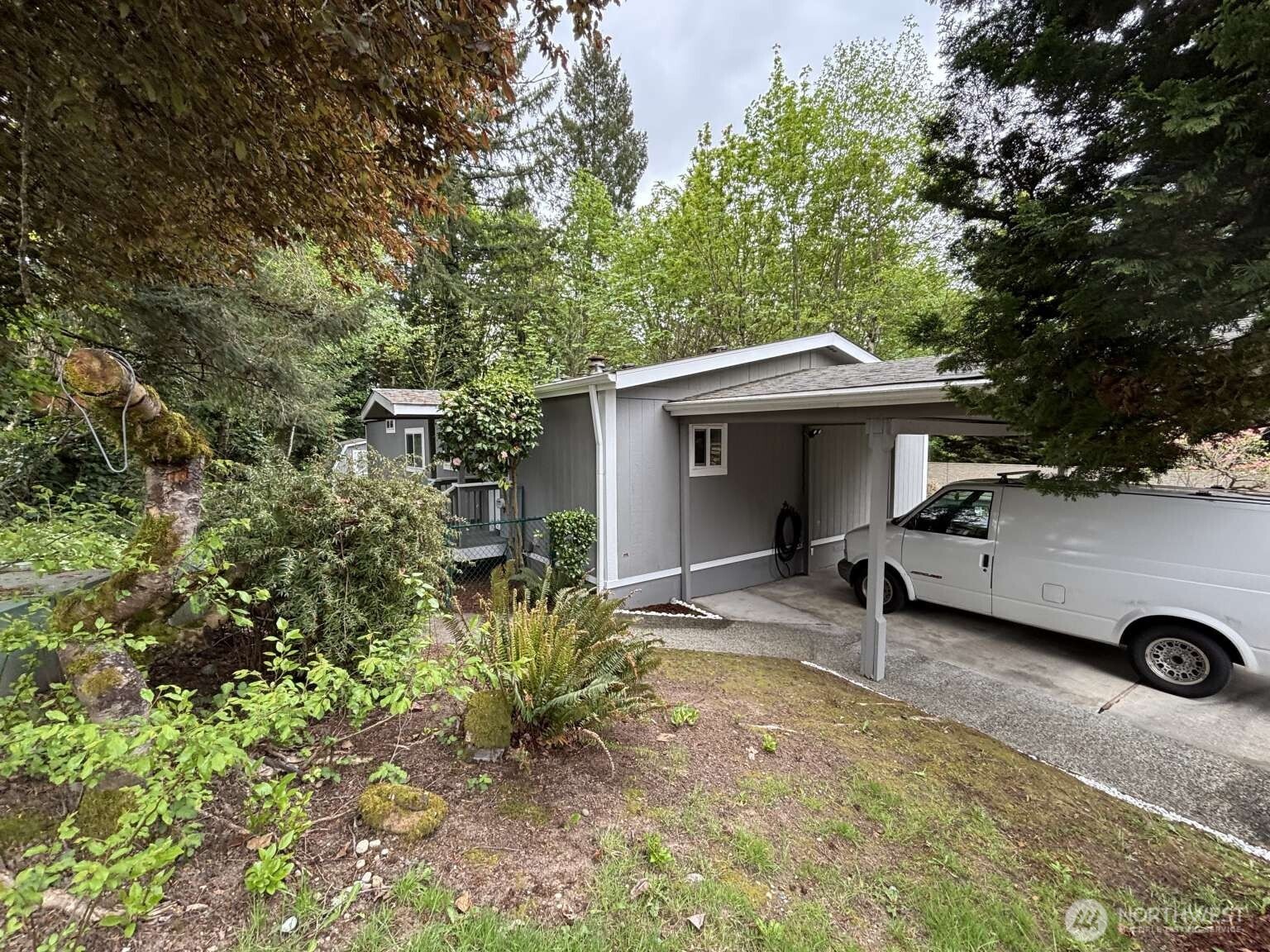 12615 Northeast 189th Street Bothell, WA 98011 - Photo 5 of 40 a front view of a house with garden