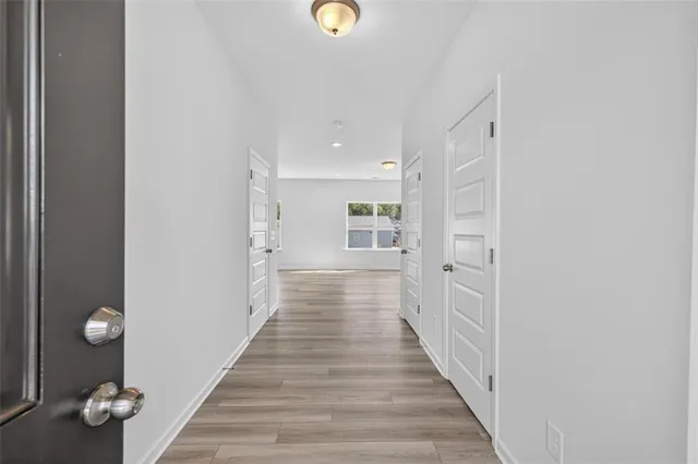 a view of a hallway with wooden floor