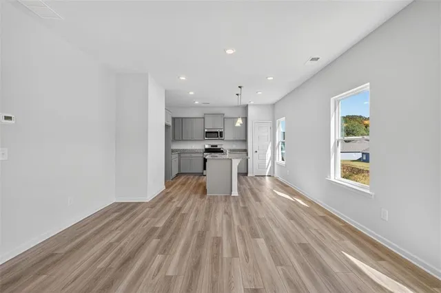 a view of kitchen with wooden floor and electronic appliances