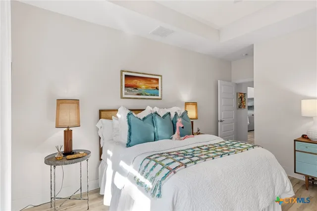 a bedroom with a bed and a lamp