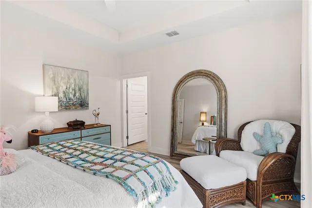 a bedroom with bed and a chair