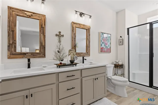 a bathroom with a double vanity sink and a mirror