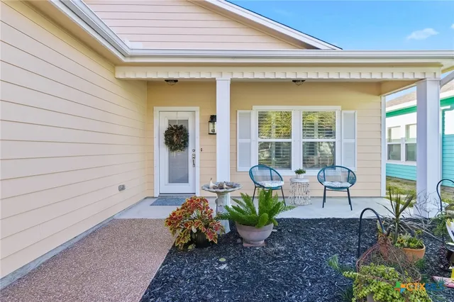a view of a house with lounge chair and a potted plant