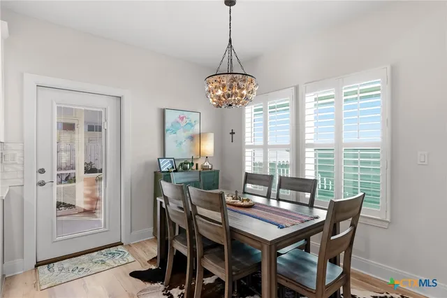 a dining room with furniture and window
