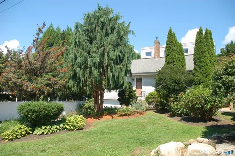 a backyard of a house with a garden and plants