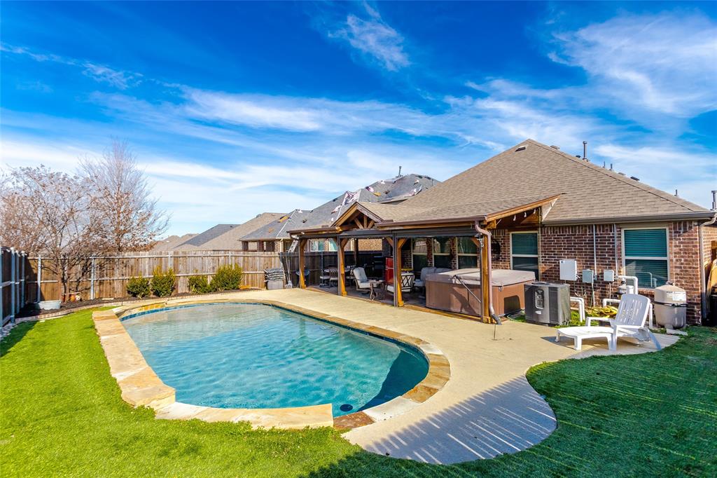 3513 Rio Grande Road Little Elm, TX 75068 - Photo 1 of 1 View of swimming pool featuring a lawn, a hot tub, and a patio area