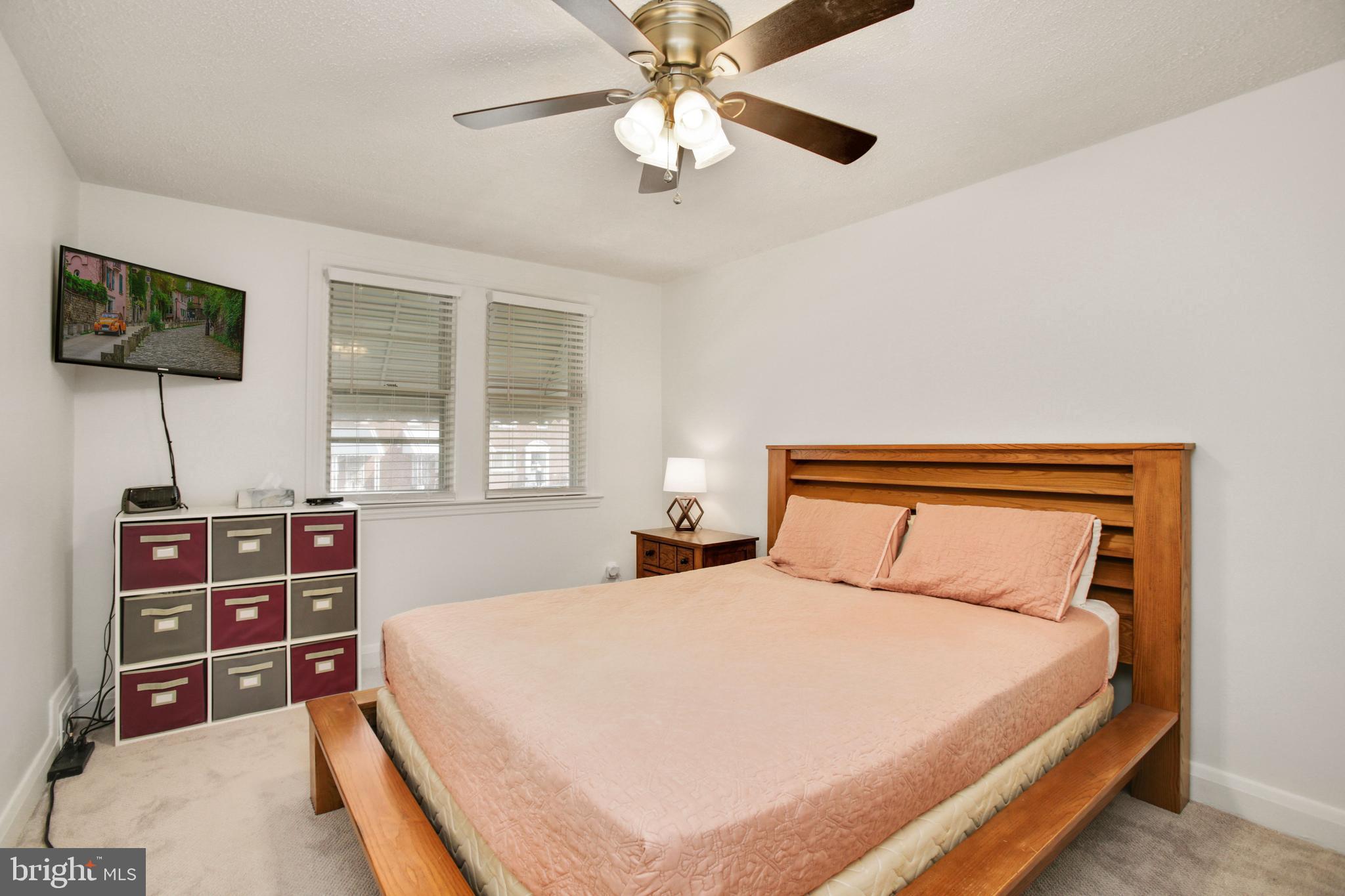 5021 West Hills Road Baltimore, MD 21229 - Photo 12 of 25 a bedroom with a bed and a flat screen tv