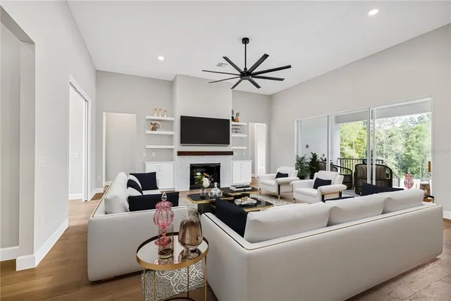 a view of an empty room with a fireplace and a window