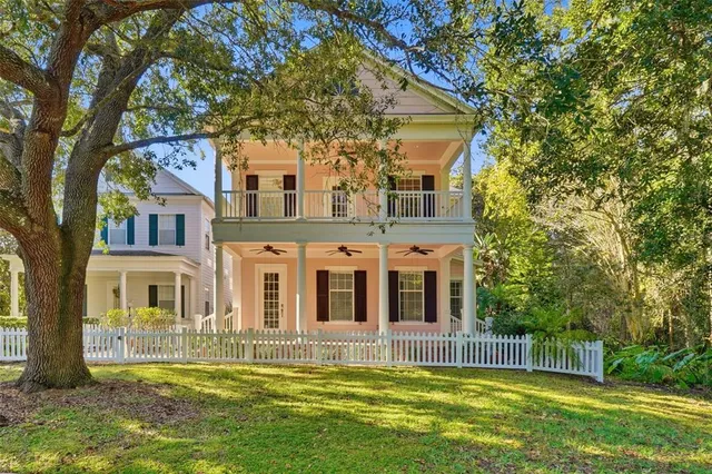 a view of a house with a small yard and flower plants