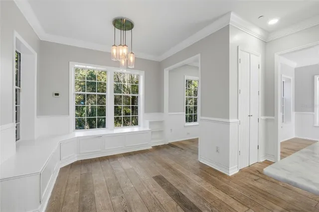 a kitchen with stainless steel appliances granite countertop a refrigerator a stove a sink a washer and white cabinets